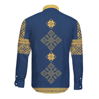 Blue long sleeve button shirt with gold back cross-shaped motif and patterned cuffs