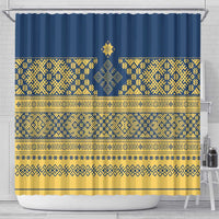 Blue shower curtain with gold geometric stripes and central emblem