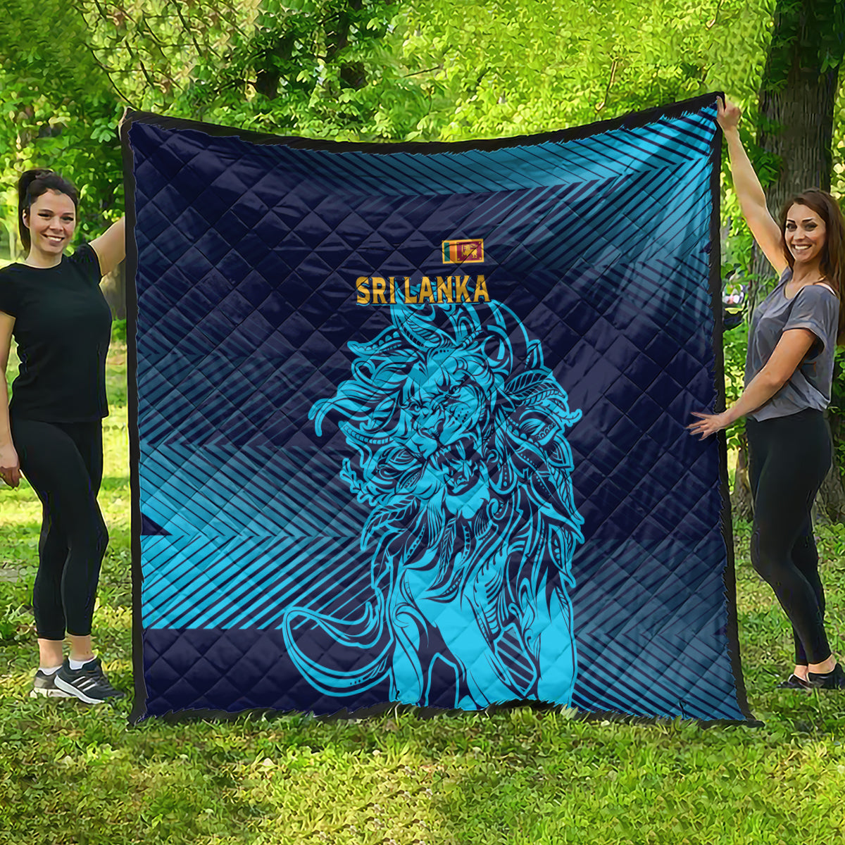 Large quilt blanket laid out outdoors in dark navy and blue stripes with lion artwork.