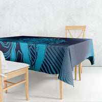 Blue and navy geometric tablecloth draped over a dining table, cyan stripe design