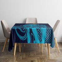 Navy and cyan geometric tablecloth on a square table with four fabric chairs