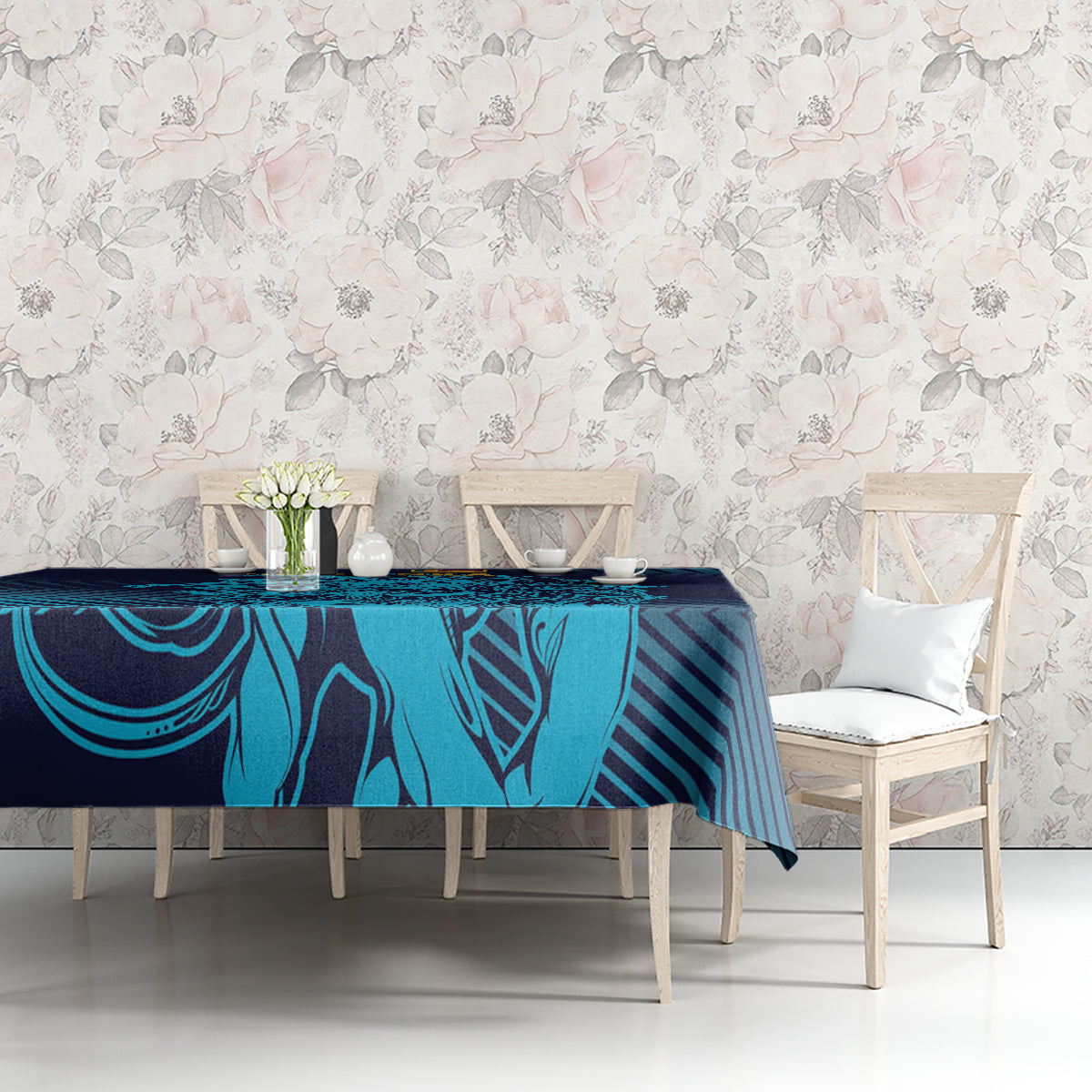 Navy and cyan patterned tablecloth on a dining table with two chairs