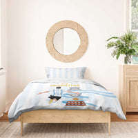 White duvet with light blue stripes and Argentina graphic, styled on a bed