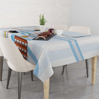 White tablecloth with light blue stripes and bold Argentina graphic across table