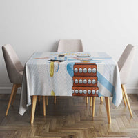 White tablecloth with light blue stripes and large Argentina-themed print on table