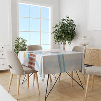 White tablecloth with light blue diagonal stripes and stacked orange Argentina graphic