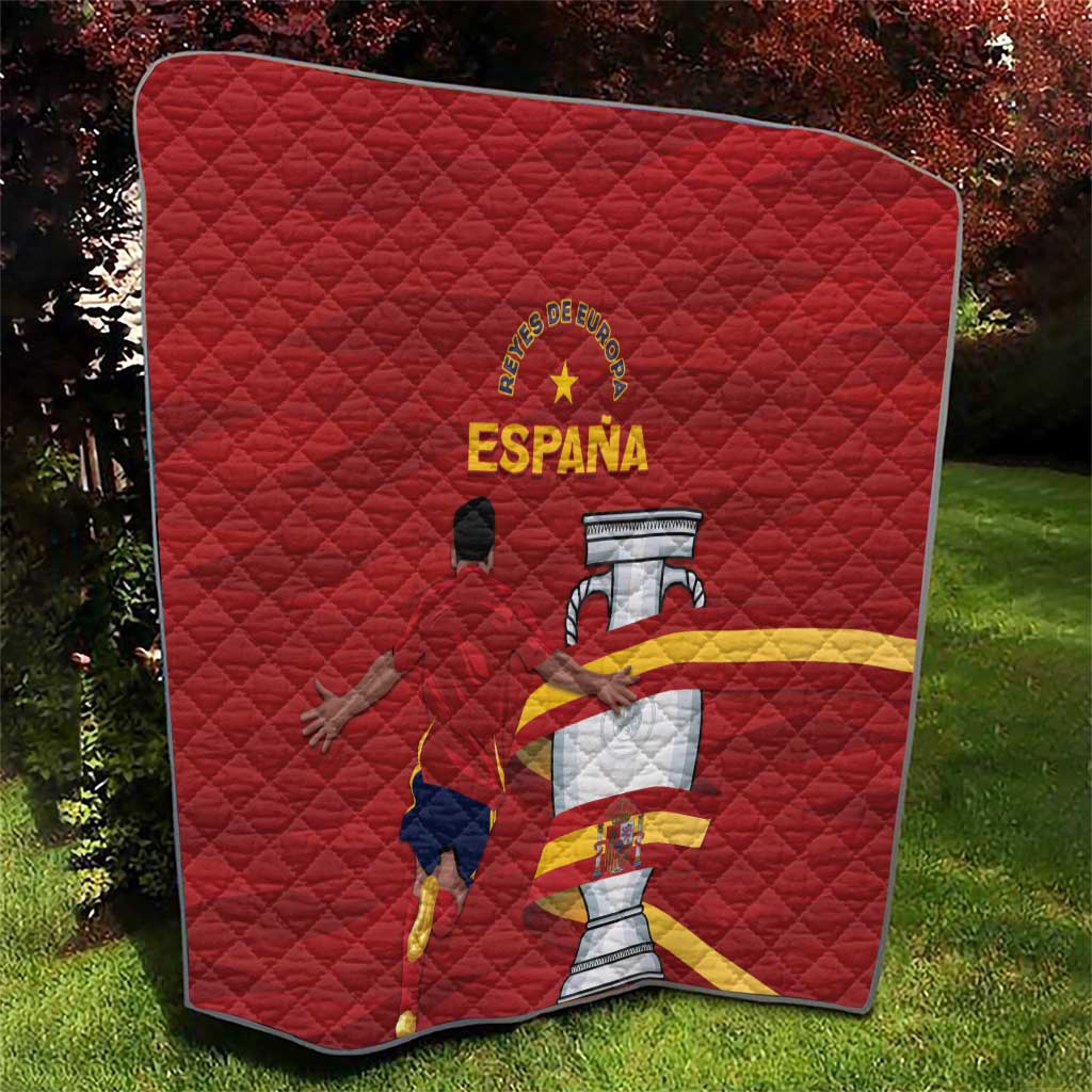 Red Spain quilt with diamond quilting and graphic crest, displayed on grass