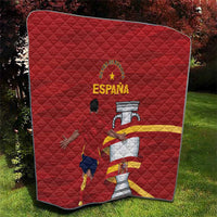 Red Spain quilt with diamond quilting and graphic crest, displayed on grass