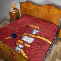 Red quilt on bed with diamond quilting and Spain crest graphic