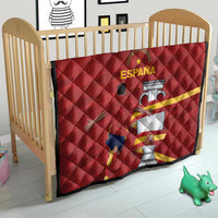 Red Spain quilt with diamond quilting on a baby bed, featuring crest graphic