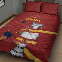 Red quilt bed set on bed with quilted diamonds, Spain wordmark and flag stripe, two shams.