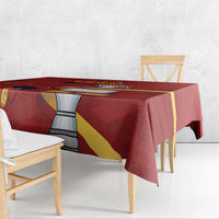 Red tablecloth with Spain graphic and yellow-red diagonal band, draped on table