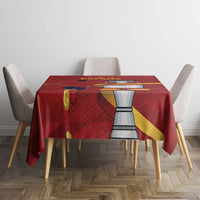 Red tablecloth with Spain graphic panel and emblem, draped over dining table