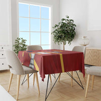 Red tablecloth with Spain graphic band across dining table with chairs