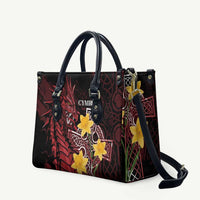 Black leather-look tote bag with red Welsh dragon and yellow star cross emblem, handles