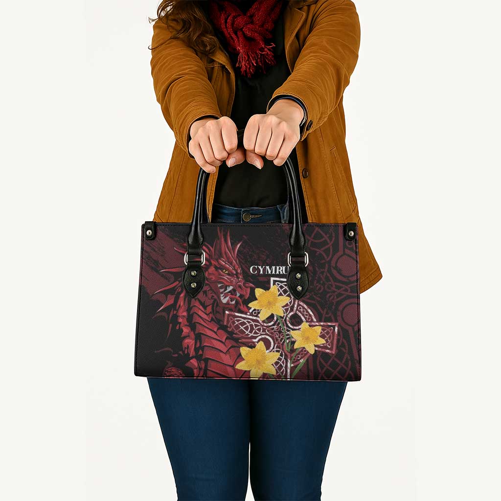 Red and black patterned leather-look tote bag with yellow star emblem and shoulder strap