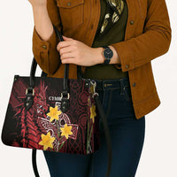 Red and black leather-look tote bag with yellow star emblem and dragon print, top handles