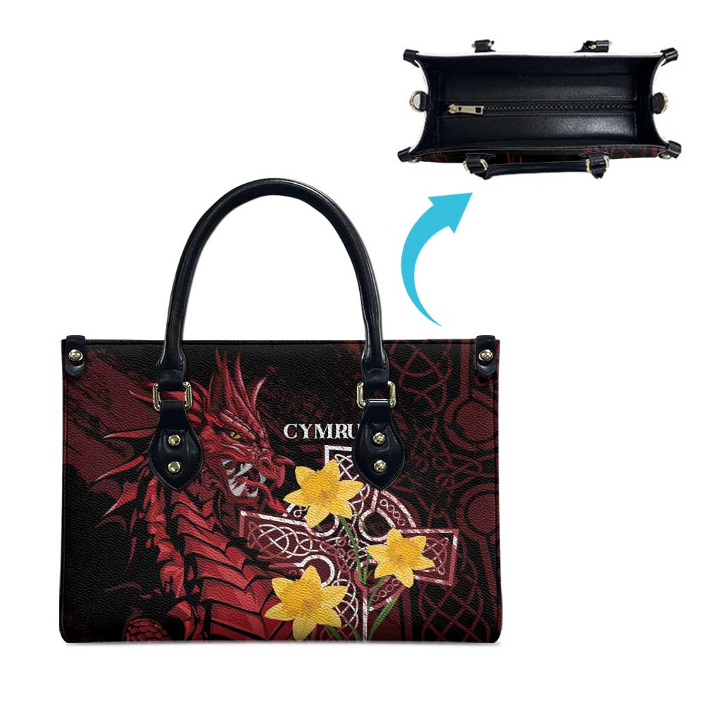 Red and black leather-look tote bag with yellow star emblem, side view with top handles