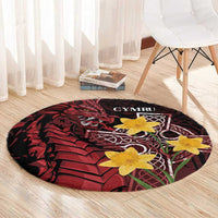 Round black and red Welsh dragon rug with yellow flowers and CYMRU center design