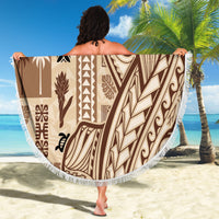 Beige round beach blanket with bold brown tapa patterns and white fringe trim