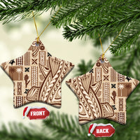 Beige star-shaped ceramic tapa ornaments with dark patterned design and gold hanging loops.