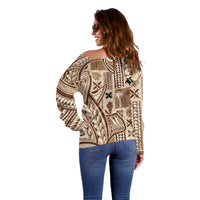 Beige off-shoulder sweater rear view with long sleeves and detailed tapa mix motifs