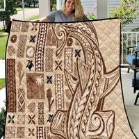 Beige quilt with tapa and tatau patchwork pattern in dark brown, quilted texture.
