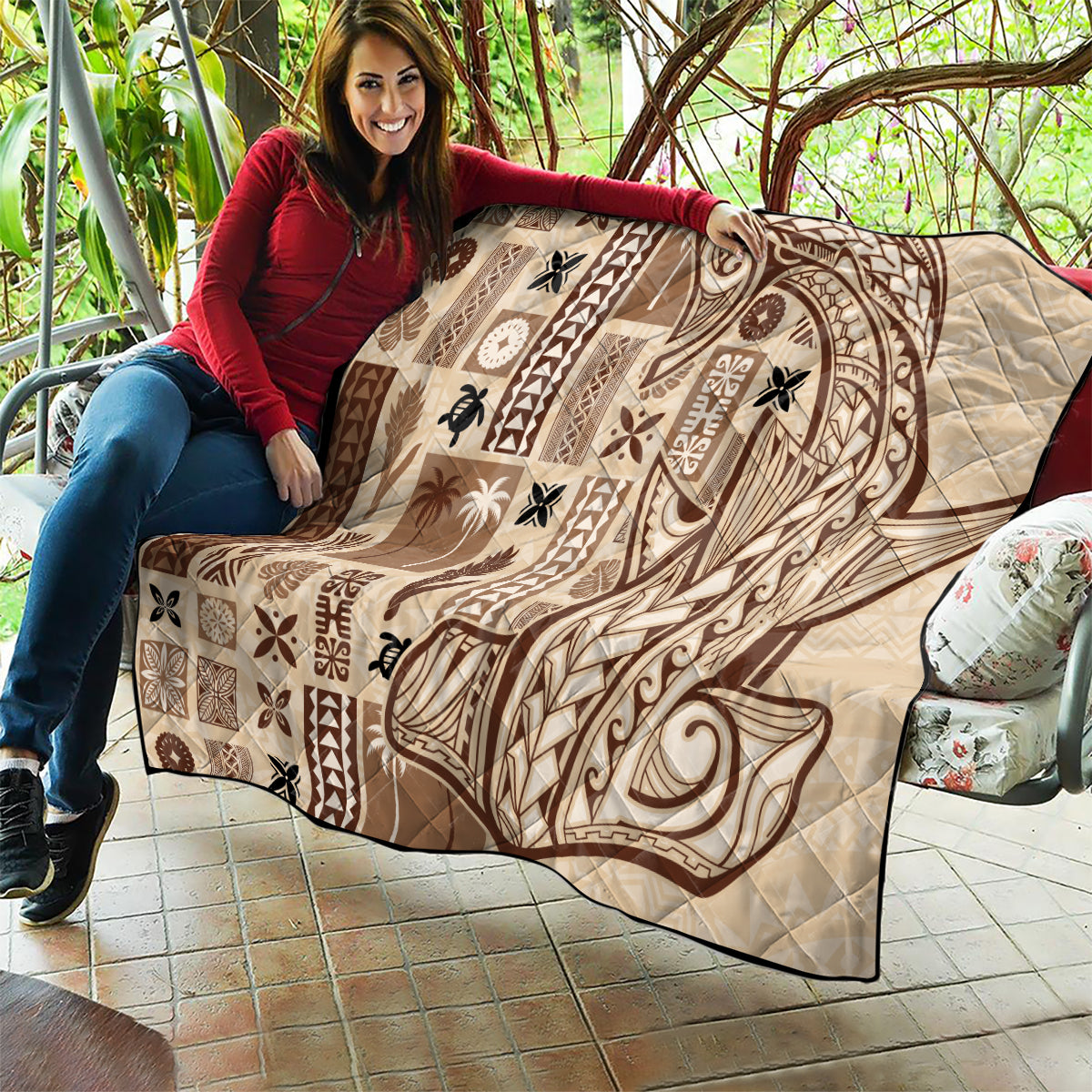 Beige quilt with dark brown tatau shield-like motif and patchwork panels, quilted.