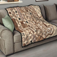 Beige quilt with dark brown tapa blocks and large swirling design, quilted throw size.