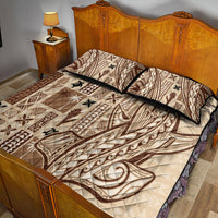 Beige and brown tapa quilt on bed with two pillow shams and dark trim