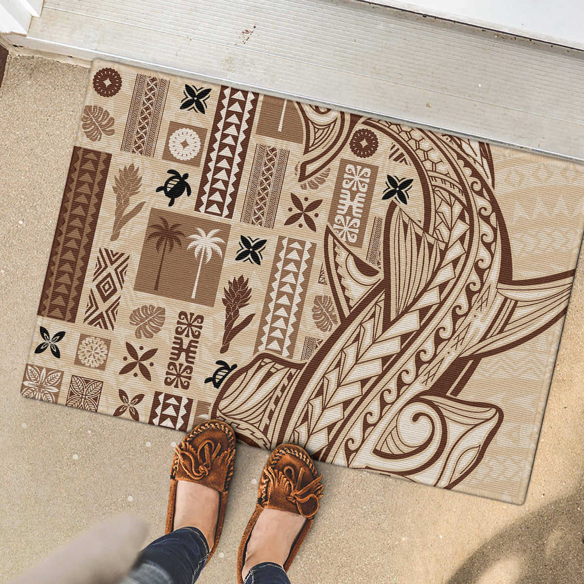 Beige and dark brown Tapa pattern rubber doormat with sea-curve swirls and palm icons
