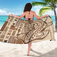 Beige tapa-pattern sarong with brown tiki motifs, shown spread wide for wrap sizing.