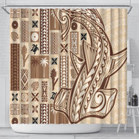 Beige shower curtain with brown tapa motifs, geometric borders, and hanging on a rod