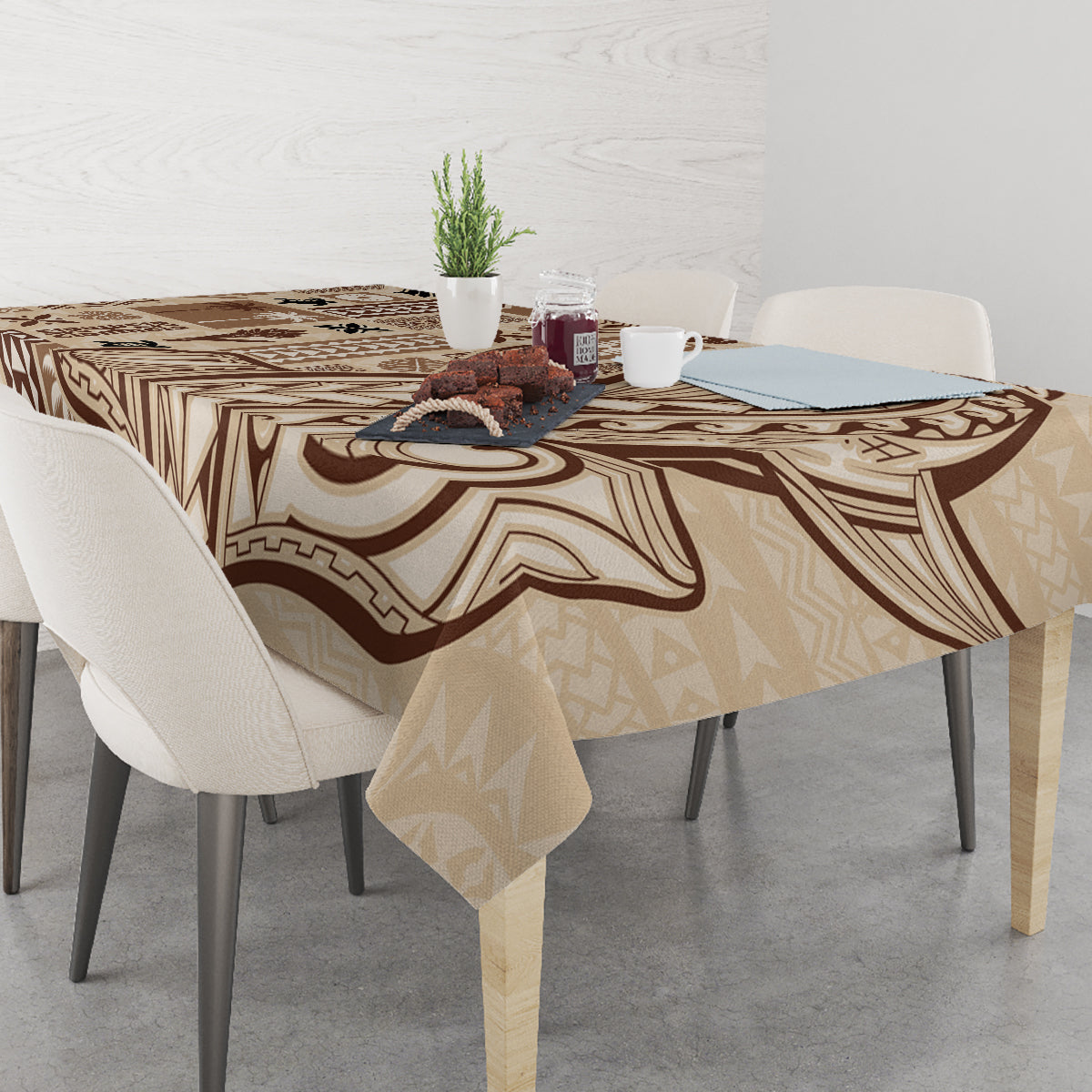 Beige tapa tablecloth draped over a table, featuring brown tribal pattern