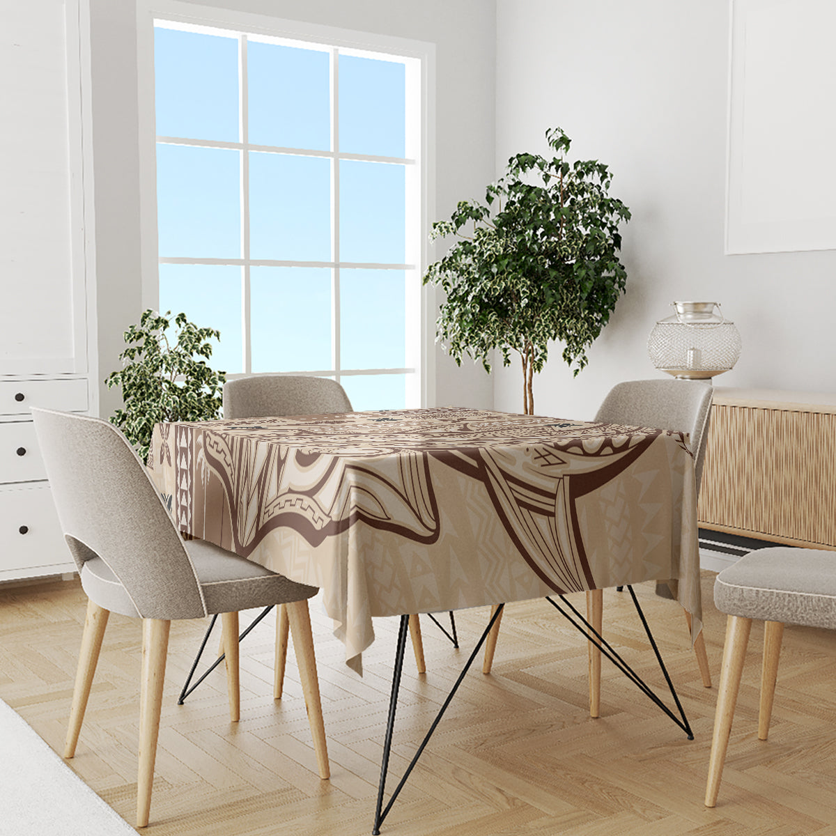 Beige tapa tablecloth with brown abstract designs covering a dining table