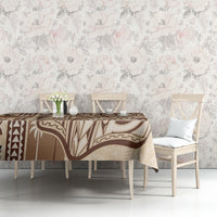 Beige tapa tablecloth with brown and cream motifs on a dining table