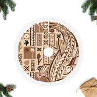 Beige tapa tree skirt with circular design, white fringed trim, and center opening
