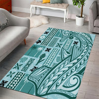 Teal geometric tribal area rug with bird and plant-like icons