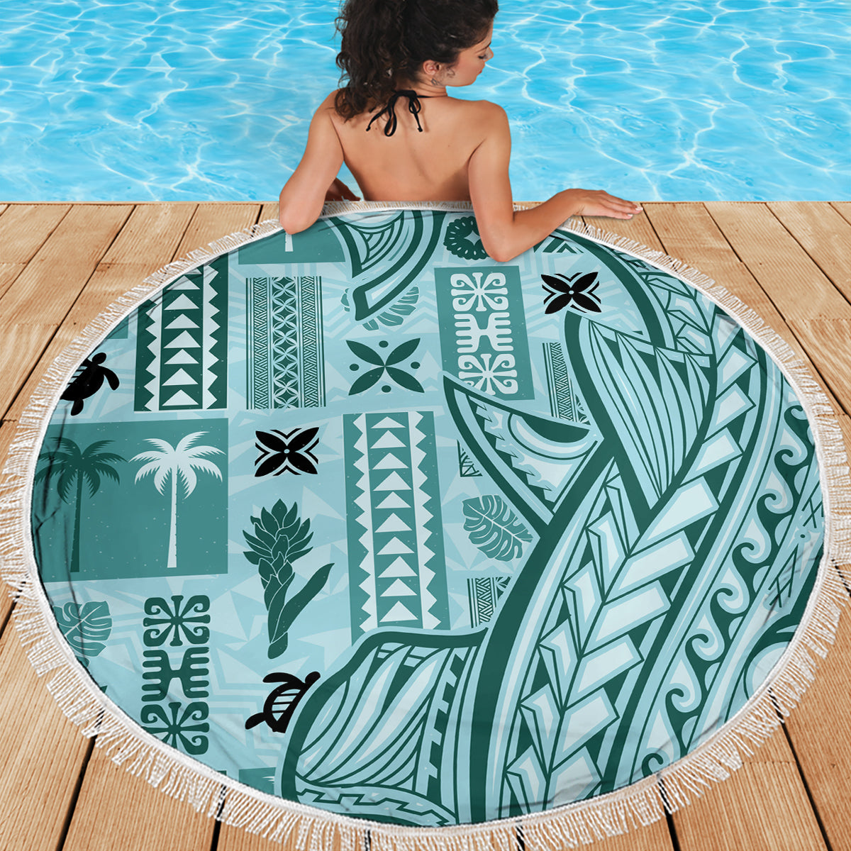 Teal round beach blanket with fringe trim and tropical tapa artwork pattern