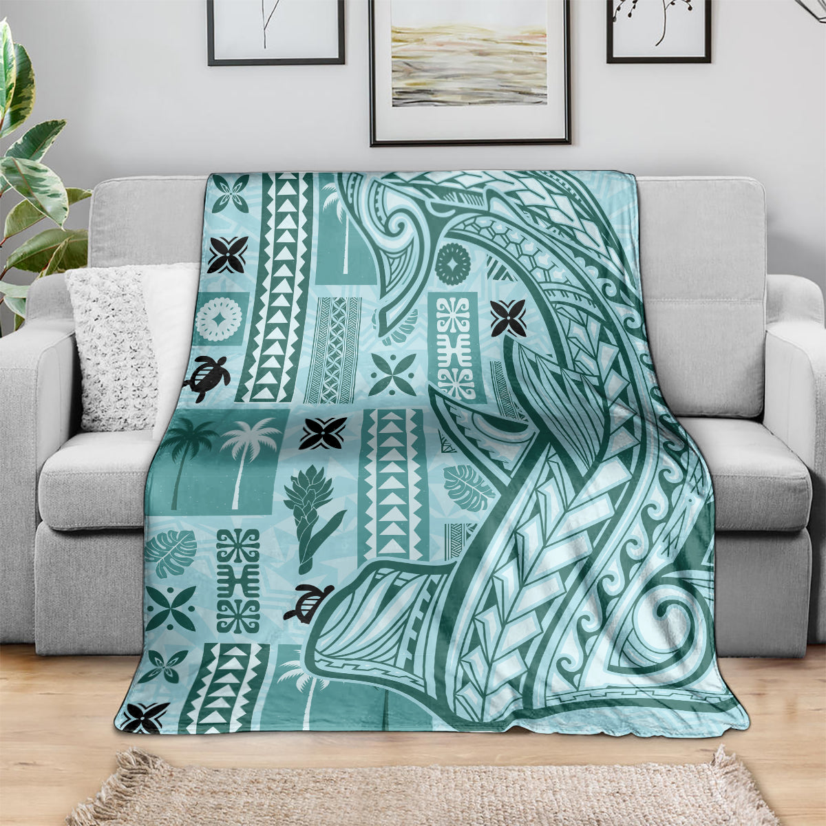 Teal tapa pattern blanket with leaf and wave motifs, spread over a sofa