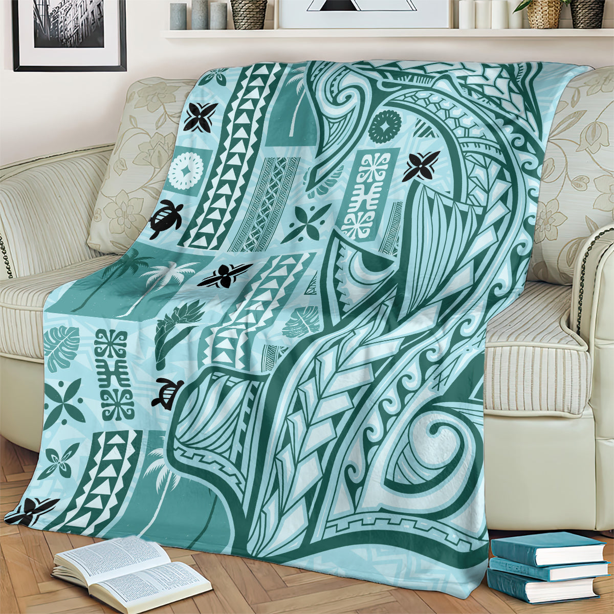 Teal tapa pattern blanket with large central bird-like figure, laid on a sofa