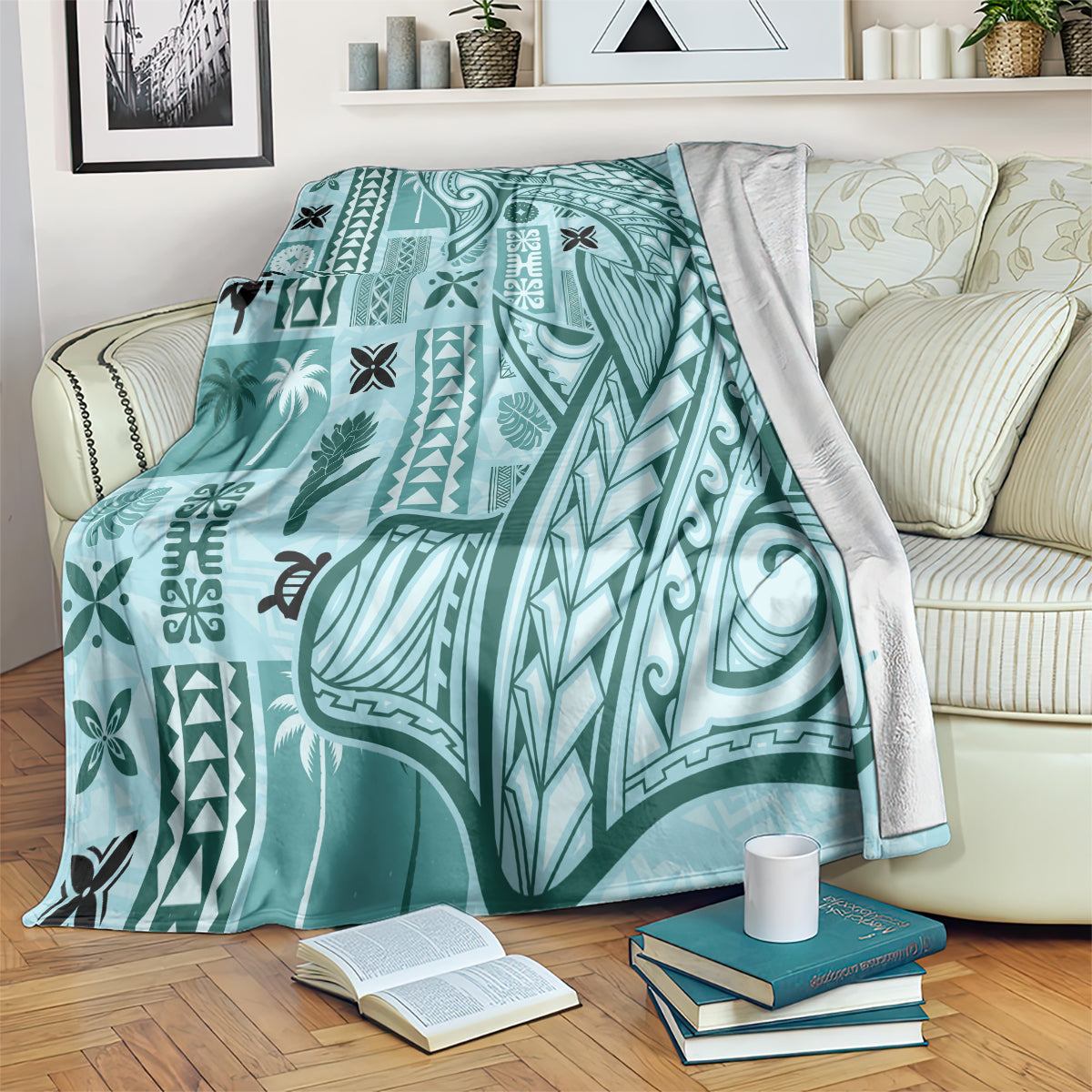Teal tapa pattern blanket with tribal border, draped over a couch and chair