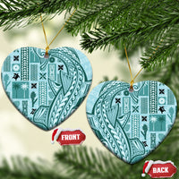 Teal heart-shaped ceramic ornament with tapa patterns, gold hanging loop on tree