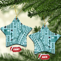 Teal star-shaped ceramic ornament with tapa patterns and gold hanging loop