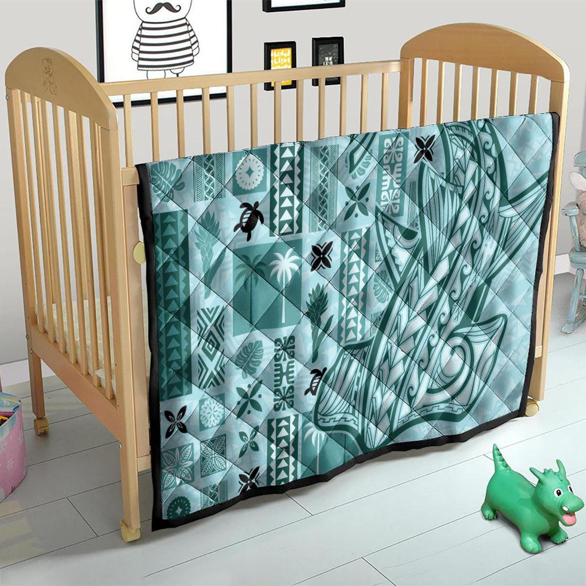 Teal tapa quilt on wooden baby bed, quilted geometric and swirl designs with black trim