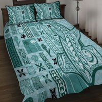 Teal patterned bed quilt with two pillow shams featuring tapa-style motifs