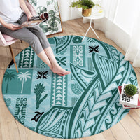 Round teal tapa-pattern carpet with bird, leaf, and geometric block designs