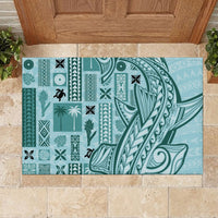 Teal rubber doormat with patterned panels, plants, and bold central wave motif