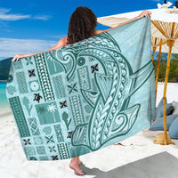 Teal tapa-style sarong with bold white tatau patterns, draped wide
