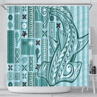Teal tapa shower curtain with bird, tiki, and floral geometric motifs along the panels